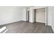 Bedroom with wood-look floors and mirrored closet doors at 3825 Pompano Se Dr, St Petersburg, FL 33705