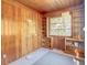 Sunroom with wood paneled walls and built-in shelving at 1003 W River Heights Ave, Tampa, FL 33603