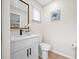 Modern bathroom with white vanity, quartz countertop, and black fixtures at 1614 E Groveleaf Ave, Palm Harbor, FL 34683