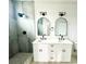 Bathroom with double vanity, marble countertop, and arched mirrors at 1906 Cherry St # 2, Tampa, FL 33607