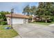 Two-story house with a three-car garage and basketball hoop in the driveway at 246 Old Oak Cir, Palm Harbor, FL 34683