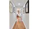 Light and bright hallway with hardwood floors and framed artwork at 36750 Us Highway 19 N # 05213, Palm Harbor, FL 34684