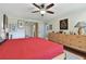 Bright bedroom with hardwood floors, ceiling fan and large bed at 36750 Us Highway 19 N # 05213, Palm Harbor, FL 34684