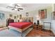 Spacious bedroom with hardwood floors, ceiling fan, and large bed at 36750 Us Highway 19 N # 05213, Palm Harbor, FL 34684