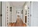 Long hallway with hardwood floors and access to bedrooms and bathrooms at 36750 Us Highway 19 N # 05213, Palm Harbor, FL 34684