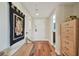 Bright entryway with hardwood floors, bench, and access to other rooms at 36750 Us Highway 19 N # 05213, Palm Harbor, FL 34684