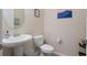 Clean and modern half bathroom with pedestal sink and toilet at 2721 Garden Falls Dr, Brandon, FL 33511