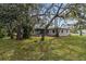 Side view of house, showcasing landscaping at 6185 Alderwood St, Spring Hill, FL 34606