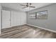 Well-lit bedroom featuring wood-look floors and built-in closet at 6185 Alderwood St, Spring Hill, FL 34606