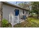 Rear view of house, showing AC unit and side door at 6185 Alderwood St, Spring Hill, FL 34606