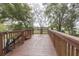 Wooden deck with brown railing and stairs at 9815 Golden Loop, New Port Richey, FL 34654