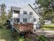 Two story home with gray siding, deck, and partial view of driveway at 9815 Golden Loop, New Port Richey, FL 34654