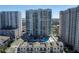 High-rise residential building with pool and lush landscaping at 450 Knights Run Ave # 1607, Tampa, FL 33602