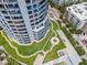 Aerial view of condo building with green rooftop garden, winding walkways, and ample parking at 1209 E Cumberland Ave # 508, Tampa, FL 33602