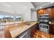 Kitchen boasting granite countertops, stainless steel appliances, and wooden cabinetry at 1209 E Cumberland Ave # 508, Tampa, FL 33602