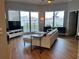 Bright living room with a large window view and a white sectional sofa at 1209 E Cumberland Ave # 508, Tampa, FL 33602