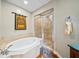 Bright bathroom featuring separate tub and shower with stylish tiled accents at 1209 E Cumberland Ave # 508, Tampa, FL 33602