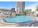 A beautiful pool with a captivating waterfall feature offers a refreshing escape with city views from the pool deck at 1209 E Cumberland Ave # 508, Tampa, FL 33602