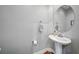 Elegant powder room featuring pedestal sink, round mirror, and stylish fixtures at 1209 E Cumberland Ave # 508, Tampa, FL 33602