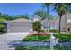 Charming one-story home featuring a well-manicured lawn, mature trees, and an attached two-car garage at 15501 Pepper Pine Ct, Land O Lakes, FL 34638