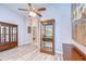 Bright living room features light wood flooring and two stylish wooden display cabinet with glass shelves at 15501 Pepper Pine Ct, Land O Lakes, FL 34638