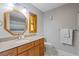 Bathroom with wood cabinets and marble countertops at 1556 Fayetteville Dr, Spring Hill, FL 34609