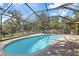 Relaxing kidney-shaped pool with screened patio at 1556 Fayetteville Dr, Spring Hill, FL 34609