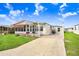 Exterior view of a manufactured home showing the driveway and surrounding area at 5251 Astrid Dr, Zephyrhills, FL 33541