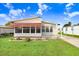 Front view of a manufactured home with a covered porch and landscaping at 5251 Astrid Dr, Zephyrhills, FL 33541