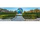 Large globe statue in landscaped area with walkways and hedges at 2293 Swedish Dr # 43, Clearwater, FL 33763