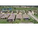 Aerial view of homes showcasing screen patios with a golf course and lake in the background at 1804 Pacific Dunes Dr, Sun City Center, FL 33573