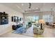 Open living room with tile floors, a ceiling fan, and a sliding glass door that provides backyard views at 1804 Pacific Dunes Dr, Sun City Center, FL 33573
