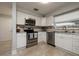 Modern kitchen with stainless steel appliances and white cabinetry at 2105 Bramblewood S Dr, Clearwater, FL 33763