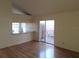 Living room with hardwood floors, kitchen pass-through and patio access at 2672 Arjay Ct, Palm Harbor, FL 34684