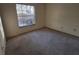 Well-lit bedroom with carpeted floors and a large window at 2672 Arjay Ct, Palm Harbor, FL 34684