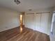 Bedroom with hardwood floors and a roomy closet at 2672 Arjay Ct, Palm Harbor, FL 34684