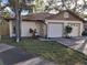 Front view of a twin home with a driveway and landscaping at 2672 Arjay Ct, Palm Harbor, FL 34684