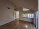 Spacious living room featuring hardwood floors and sliding glass doors at 2672 Arjay Ct, Palm Harbor, FL 34684