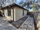 House exterior showcasing a side view with patio and landscaping at 2672 Arjay Ct, Palm Harbor, FL 34684