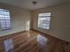 Bedroom with hardwood floors and two windows offering natural light at 2672 Arjay Ct, Palm Harbor, FL 34684