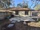 Backyard view showcasing patio, wooden fence, and house exterior at 2672 Arjay Ct, Palm Harbor, FL 34684