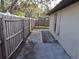 Backyard with a paved patio and wooden fence at 2672 Arjay Ct, Palm Harbor, FL 34684