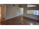 Open living room with hardwood floors and access to bathroom at 2672 Arjay Ct, Palm Harbor, FL 34684