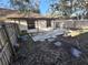 Backyard with patio, wooden fence, and partial house view at 2672 Arjay Ct, Palm Harbor, FL 34684