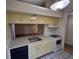 Updated kitchen with white appliances and a pass-through to dining area at 2672 Arjay Ct, Palm Harbor, FL 34684