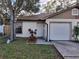 Front view of a twin home with a driveway and landscaping at 2672 Arjay Ct, Palm Harbor, FL 34684