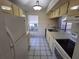 Clean and functional kitchen with white appliances and wood flooring at 2672 Arjay Ct, Palm Harbor, FL 34684