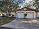 Front view of a twin home with a driveway and landscaping at 2672 Arjay Ct, Palm Harbor, FL 34684
