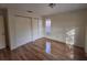 Sunny bedroom, featuring hardwood floors and a large closet at 2672 Arjay Ct, Palm Harbor, FL 34684