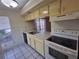 Efficient kitchen with white cabinets and a view to the backyard at 2672 Arjay Ct, Palm Harbor, FL 34684